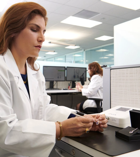GIA gemologist examining a stone in the laboratory